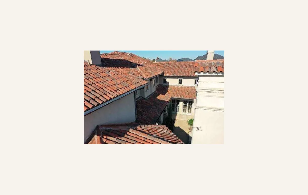 Cracked tile roofing surface on a residential roof